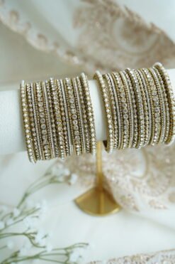 An elegant stack of South Asian bangles featuring a vibrant mix of different stone detailing and crystal embellishments by Seyora Jewels.