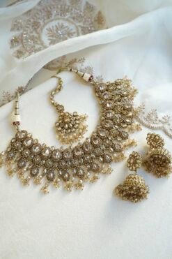 Seyora Jewels Tanya necklace set featuring champagne stones and hanging champagne crystal beads with matching jhumka earrings and maang tikka.