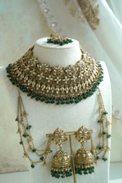Seyora Jewels bridal jewelry set featuring a champagne stone necklace with emerald green beads, matching jhumka earrings with kanchain, maang tikka, and passa